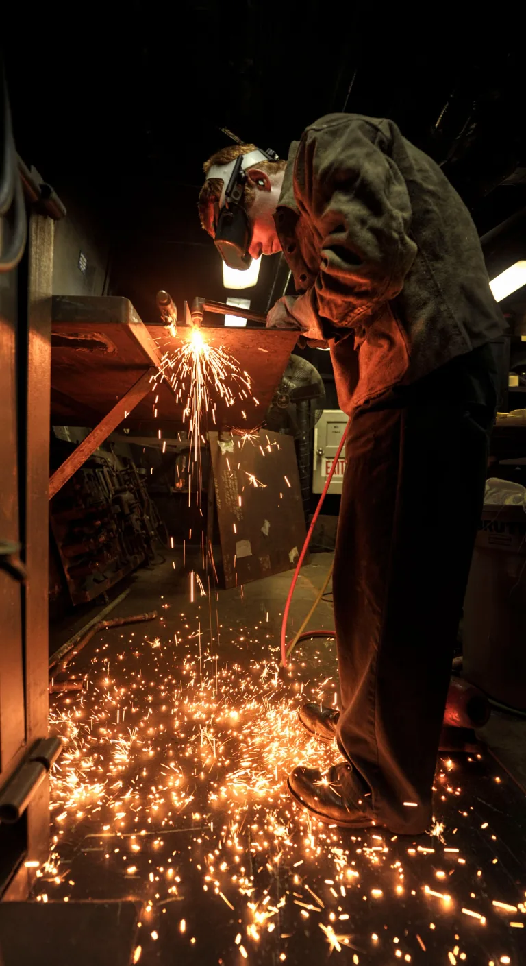 A U.S. Navy Hull Maintenance Technician 3rd Class Robert Frey fabricates a steel countertop aboard the aircraft carrier USS…