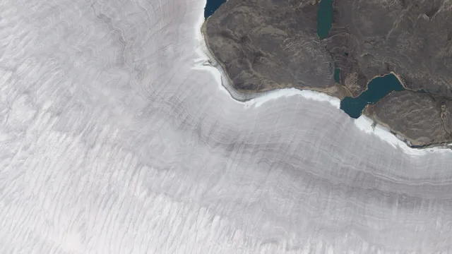 Natural-colour image of the Barnes Ice Cap, a bowling-pin-shaped glacier on Canada’s Baffin Island.