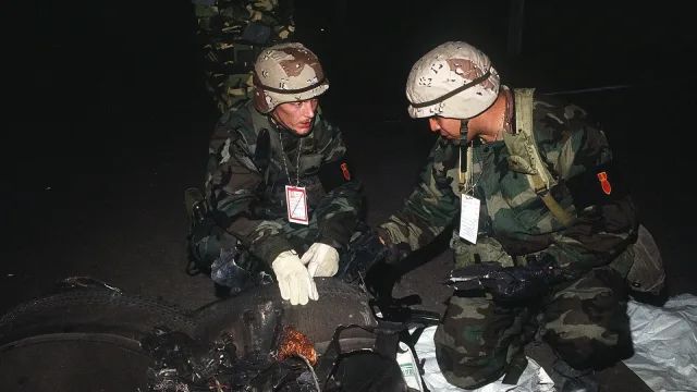 Explosive ordnance disposal technicians inspect the remains of an Iraqi Scud missile that was shot down by an intercepting P…