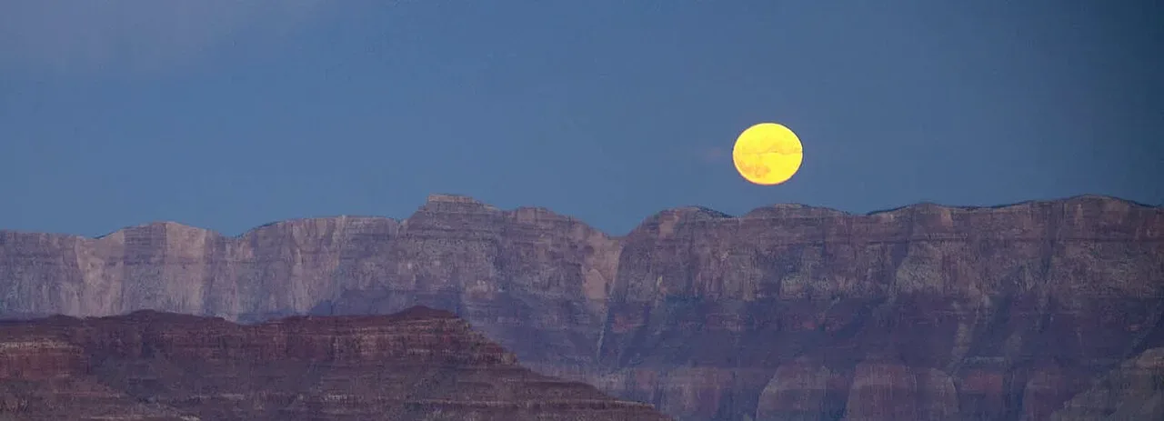 The Full Moon rising over the canyon on the evening of Sunday, October 9, 2022, as seen from Yaki Point on the South Rim.