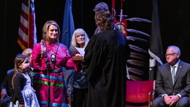 Lt. Governor Peggy Flanagan is sworn in, with her are her parents, daughter Siobhan Hellendrung, 5 and partner Tom Weber