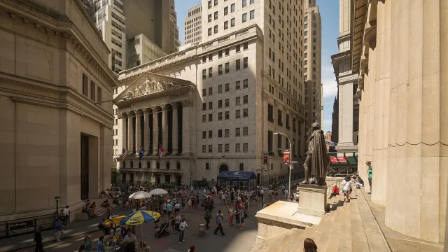 Intersection of Broad Street and Wall Street with New York Stock Exchange and the Federal Hall.