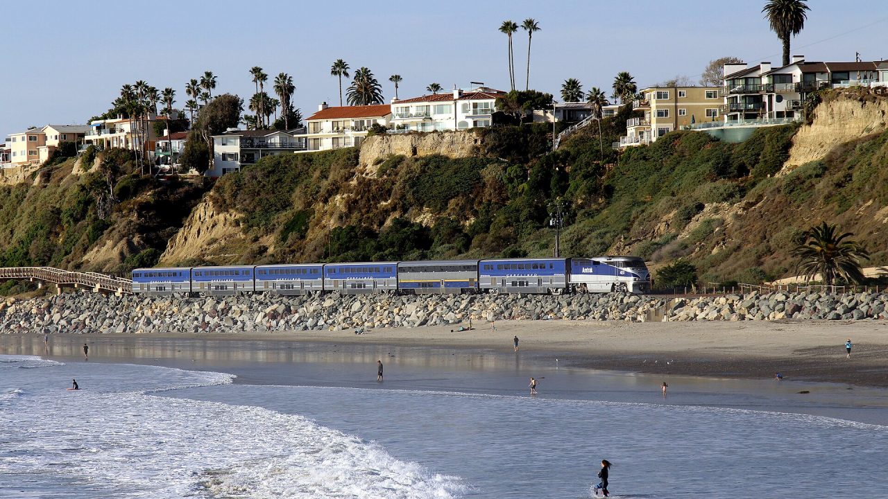 An Amtrak Pacific Surfliner train passes San Clemente Beach in California.