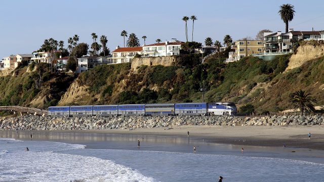 An Amtrak Pacific Surfliner train passes San Clemente Beach in California.