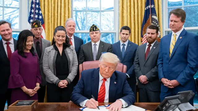 President Donald J. Trump signs S.153 , The Supporting Veterans in STEM Careers Act, in the Oval of the White House.