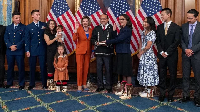 Rep. Mary Peltola (D-AK) is sworn in by House Speaker Nancy Pelosi, as her family looks on.
