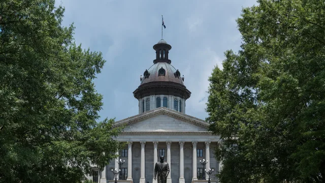 A southeast view of the South Carolina State House and the Strom Thurmond statue, Columbia