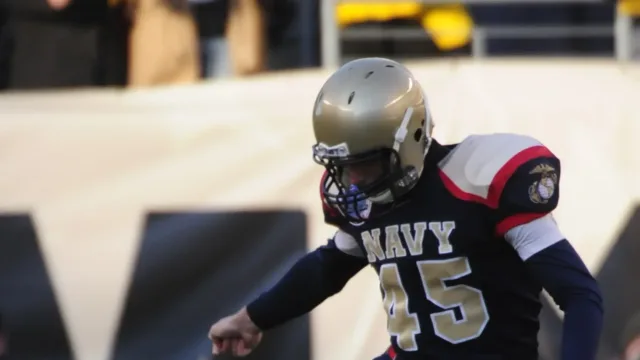 US Navy 091212-N-9693M-888 Navy kicker John Teague (^45) kicks off to start the 110th Army-Navy college football game at Lin…